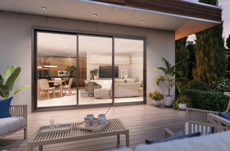 Multi-slide patio door opening to oceanfront deck with bright coastal interior