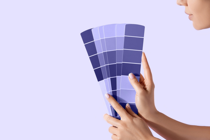 Hands holding swatches of various colors, including Pantone’s paint color of the year, Very Peri Hands holding swatches of various colors, including Pantone’s paint color of the year, Very Peri