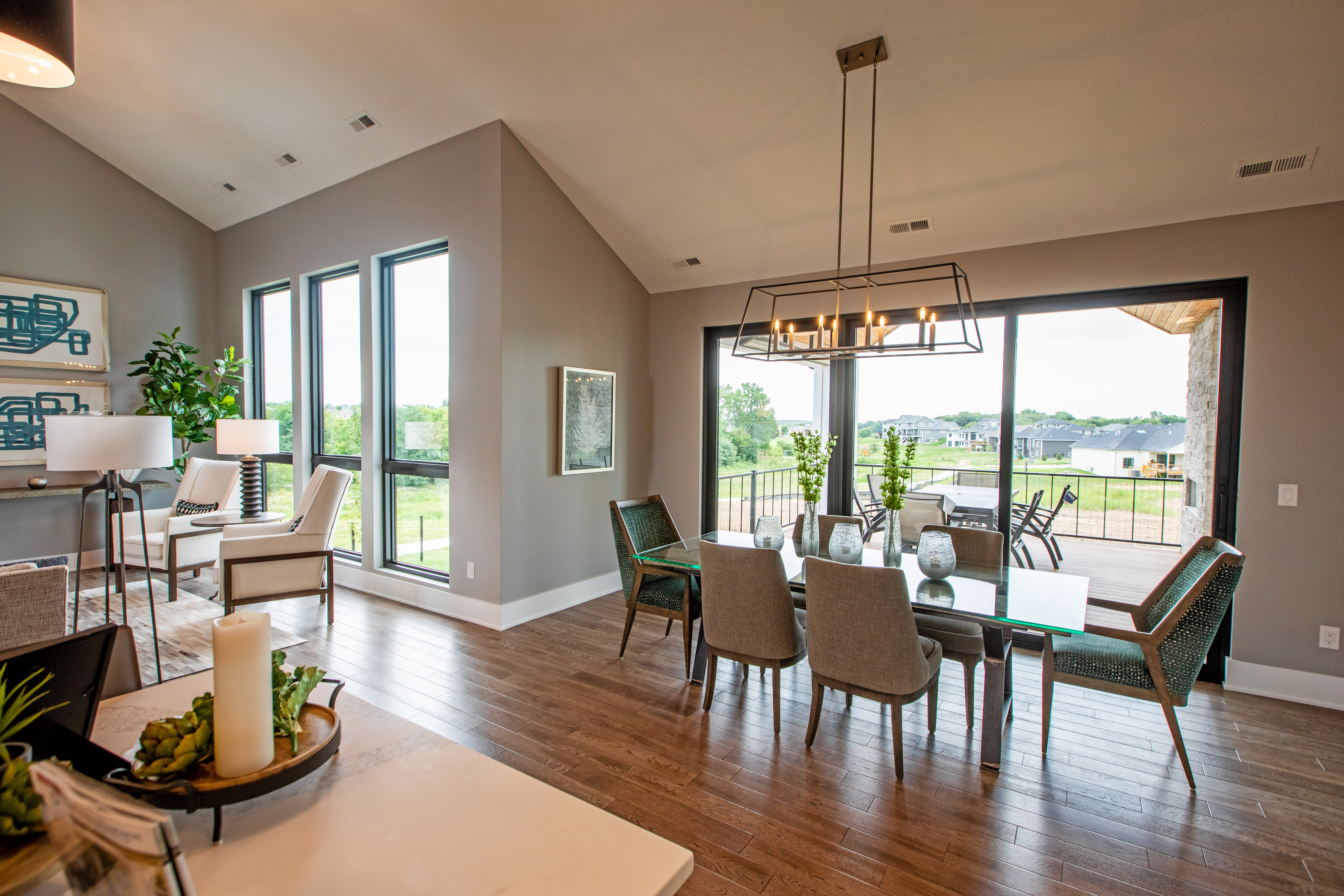 A living area with a black sliding patio door connecting to a porch.