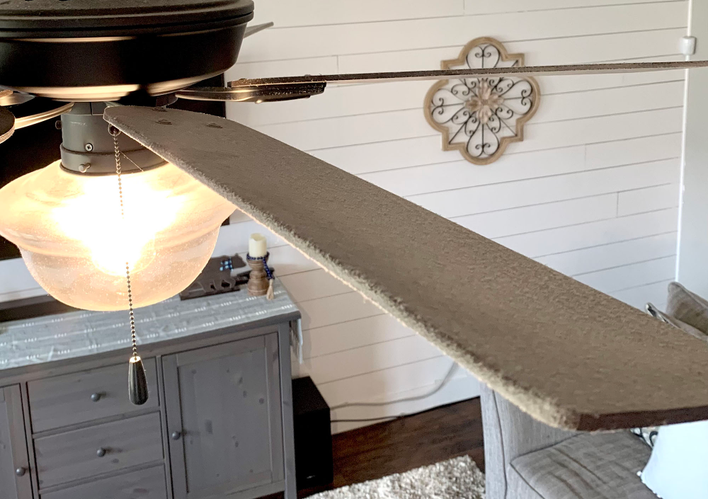 Dusty ceiling fan in the room of a house.