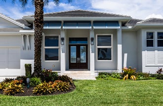 Window World 8500 Aluminum Series White Single-Hung Windows on a Luxury House Exterior in Marco Island Florida