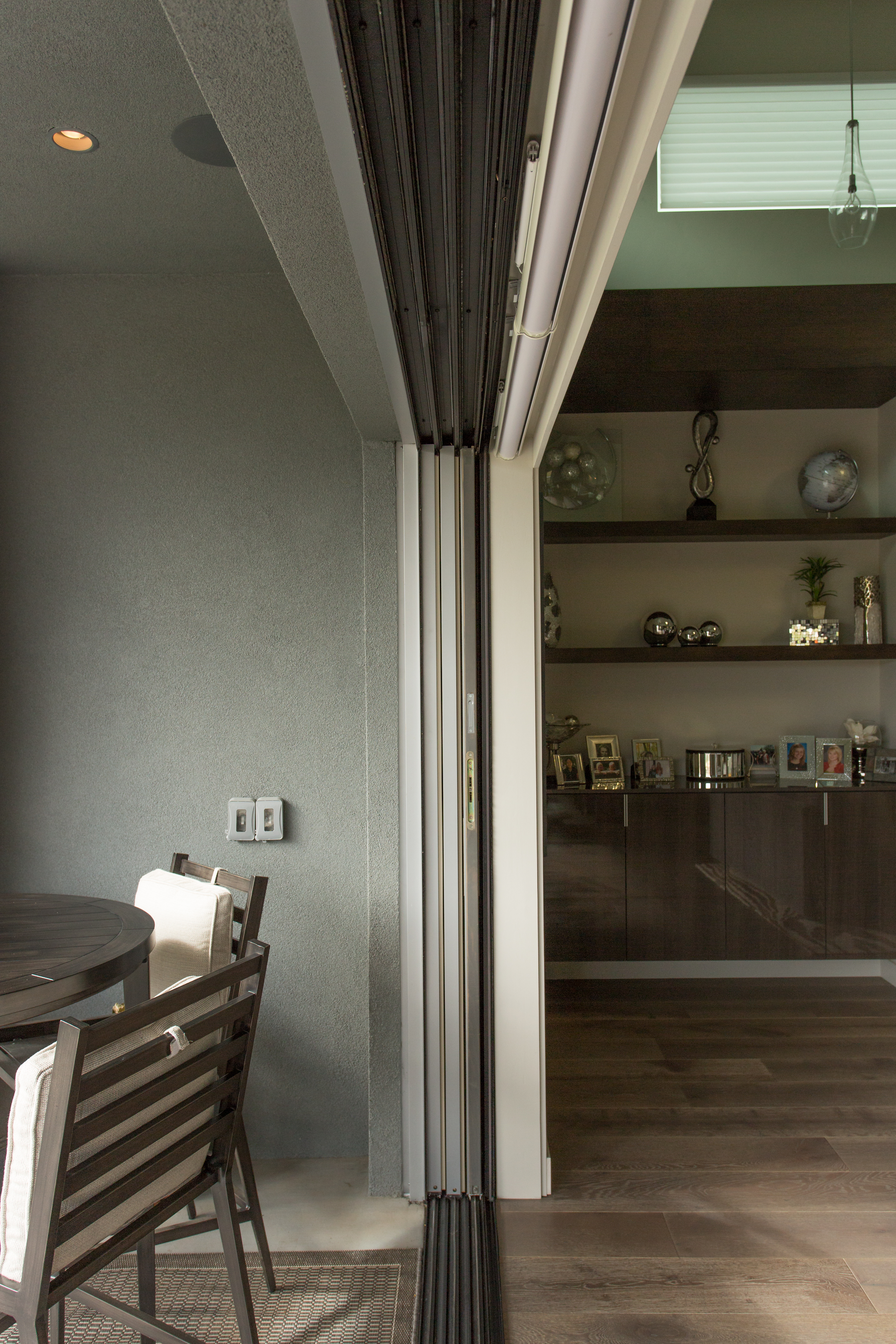 A side view of a multi-slide patio door fully concealed in a wall pocket.