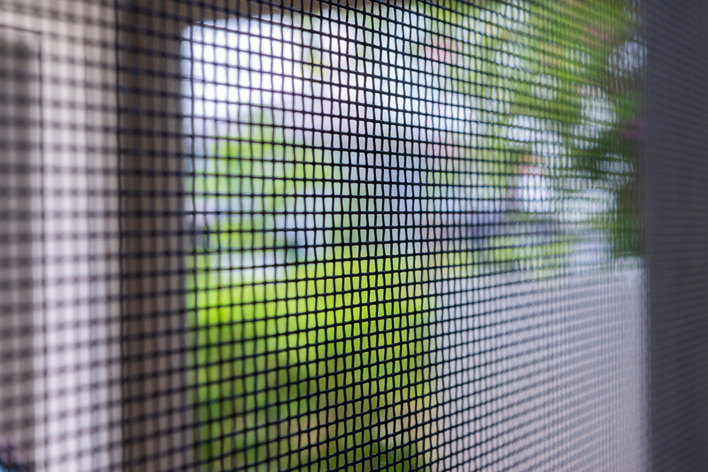A close-up of the wire screen in a screen door A close-up of the wire screen in a screen door