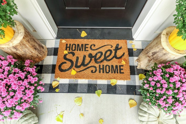 Door mat which reads Home Sweet Home with flowers on both sides