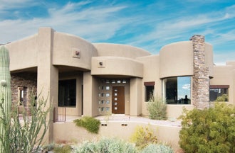 Stucco home with a woodgrain entry door