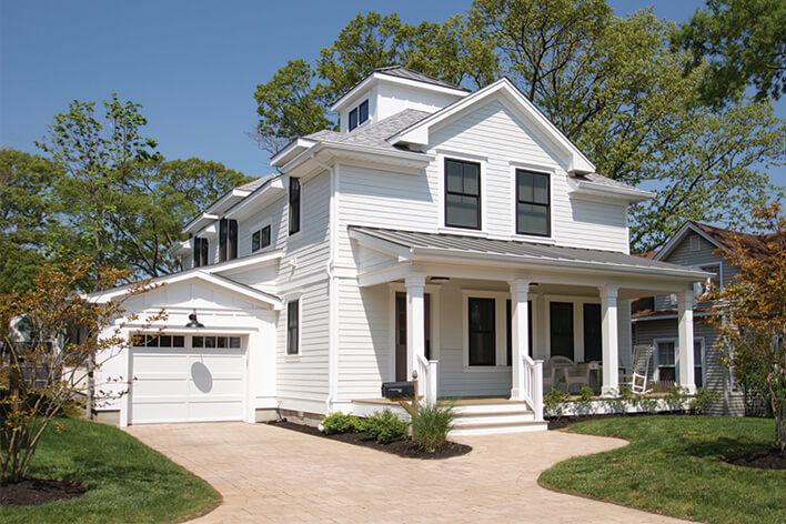 All-white farmhouse-style home with black windows