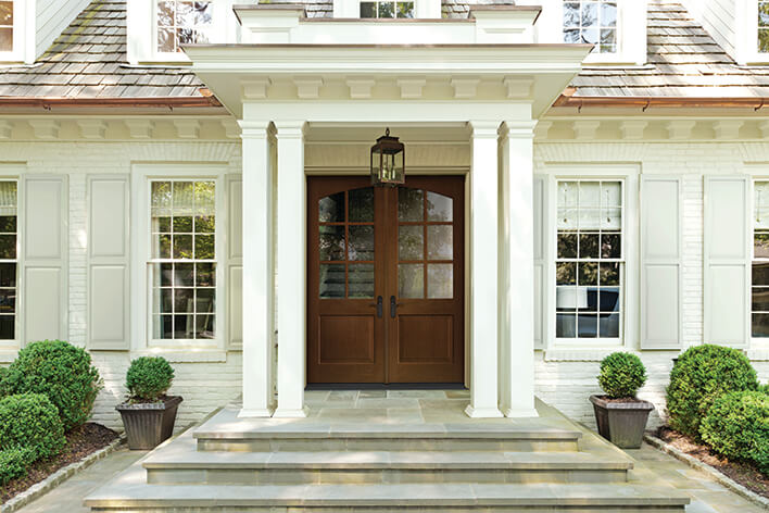 Front of a house with large retrofit windows