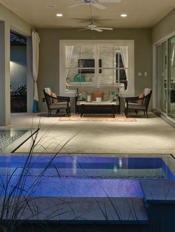 Window World 8500 Aluminum series white windows under a porch with a small pool area.