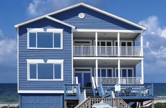 Impact-resistant sliding window with sleek white vinyl frame and dual sliding sash.