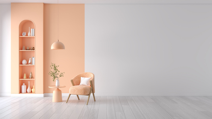 An otherwise stark room with one section painted and decorated in the Pantone 2024<br>Color of the Year to emphasize how it warms and harmonizes the space.