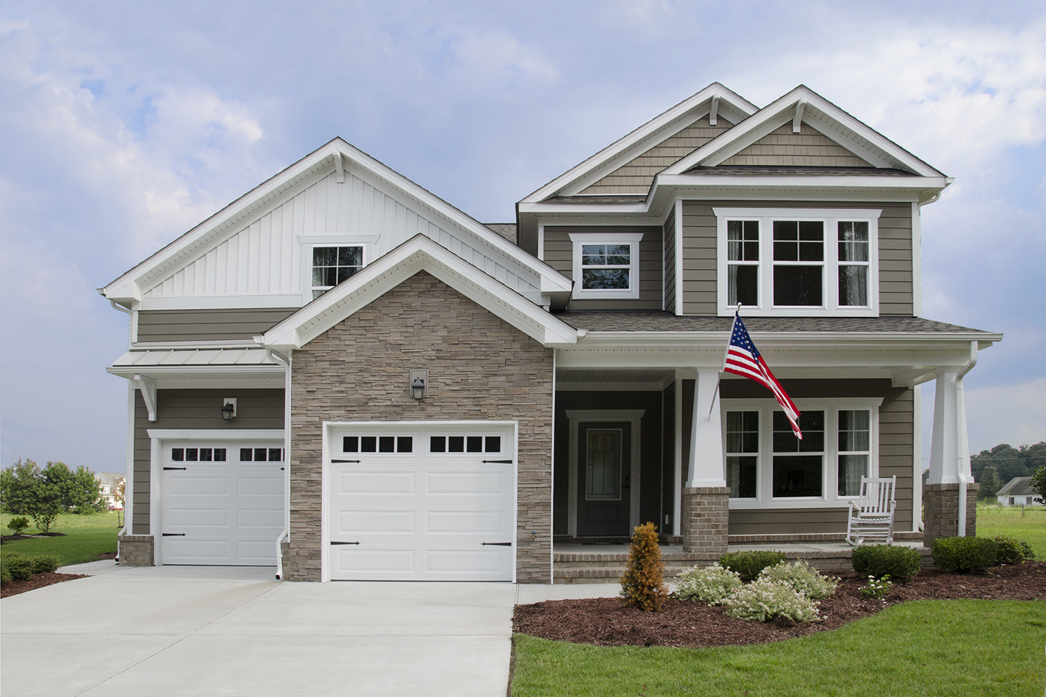 White new construction windows on a 2 story home with an attached double garage