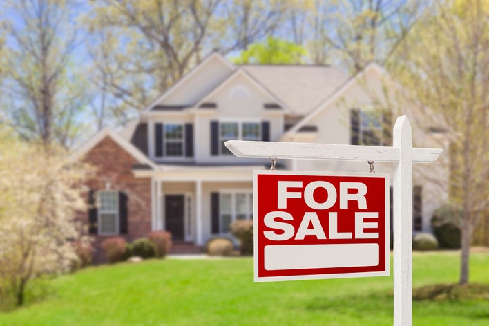 For sale sign in front of a home.