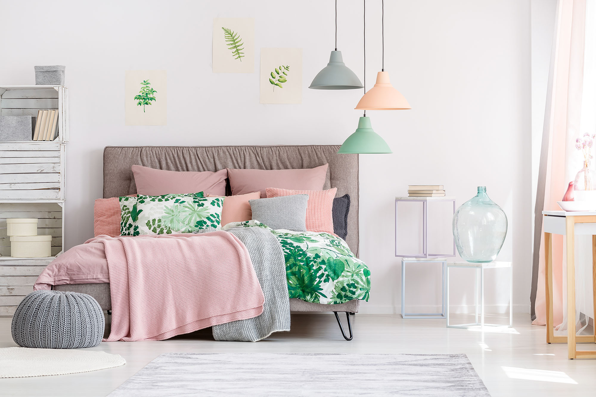 An open and airy bedroom decorated with botanical elements and Peach Fuzz-colored<br>accents