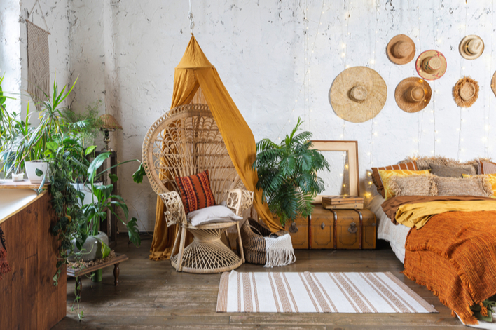 Gold and orange bohemian style bedroom with plants