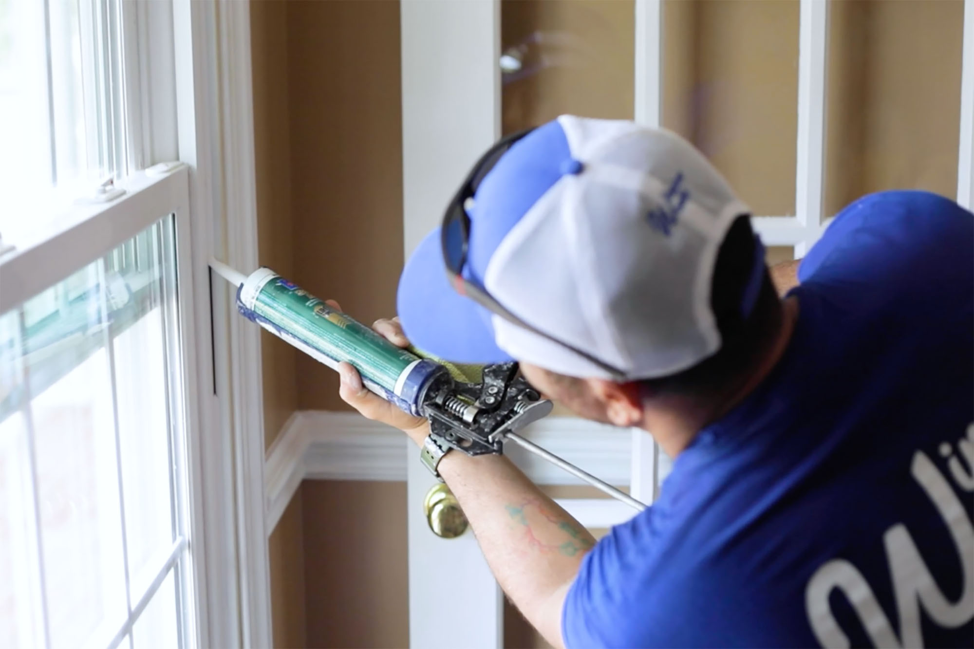 View of window replacement contractor completing a job inside of the home