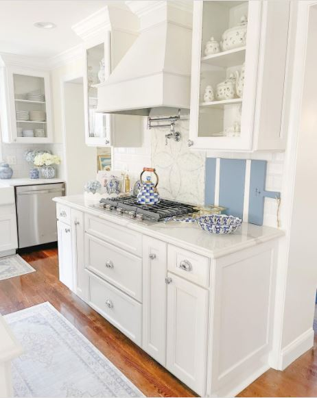 A beautiful classic white kitchen with blue kitchenware