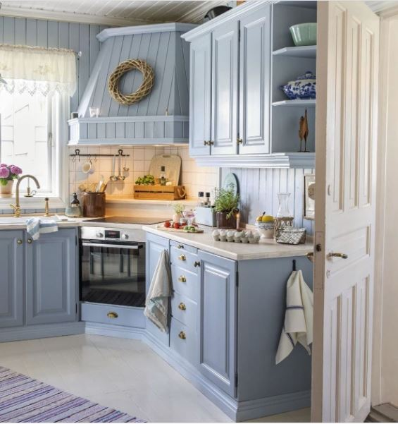 A cute kitchen with powder blue cabinets