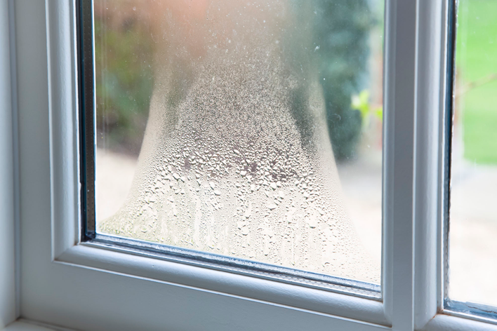 Close-up of condensation between the panes of a window.