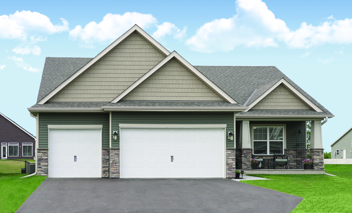 White vertical short panel garage door with no windows installed on a residential home.