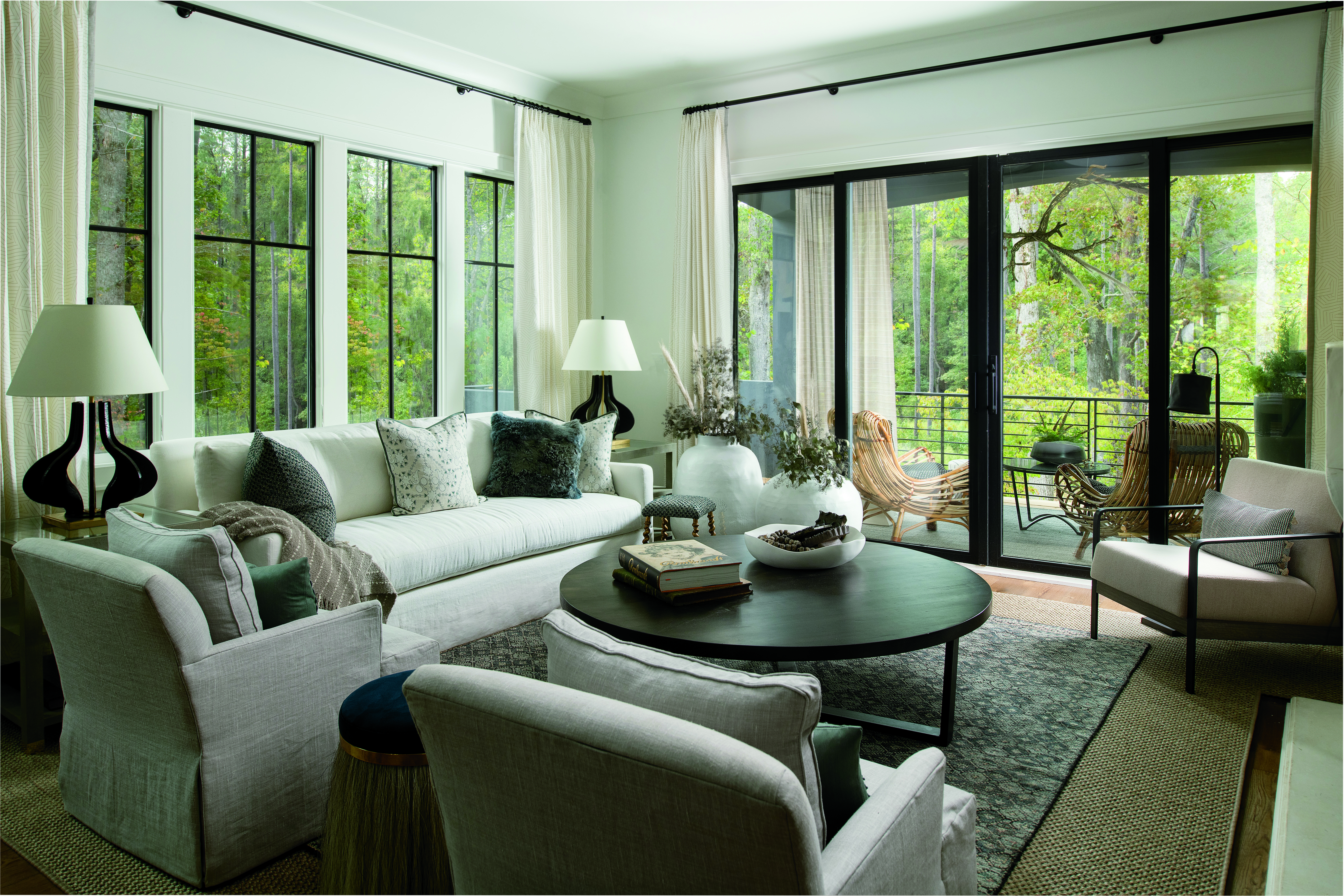 A living room with a black bi-parting sliding patio door connecting to a covered porch.