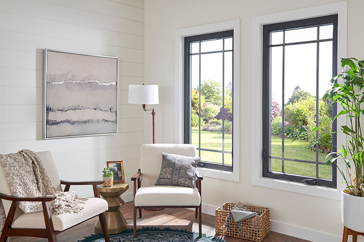 Expensive-looking sitting room in a home with two large casement windows