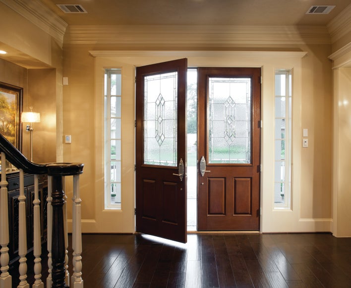 Open fiberglass exterior doors with decorative privacy glass to obscure the home’s<br>interior.