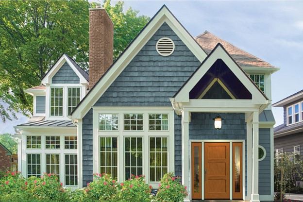 Blue cottage-style home with white trim and wood front door