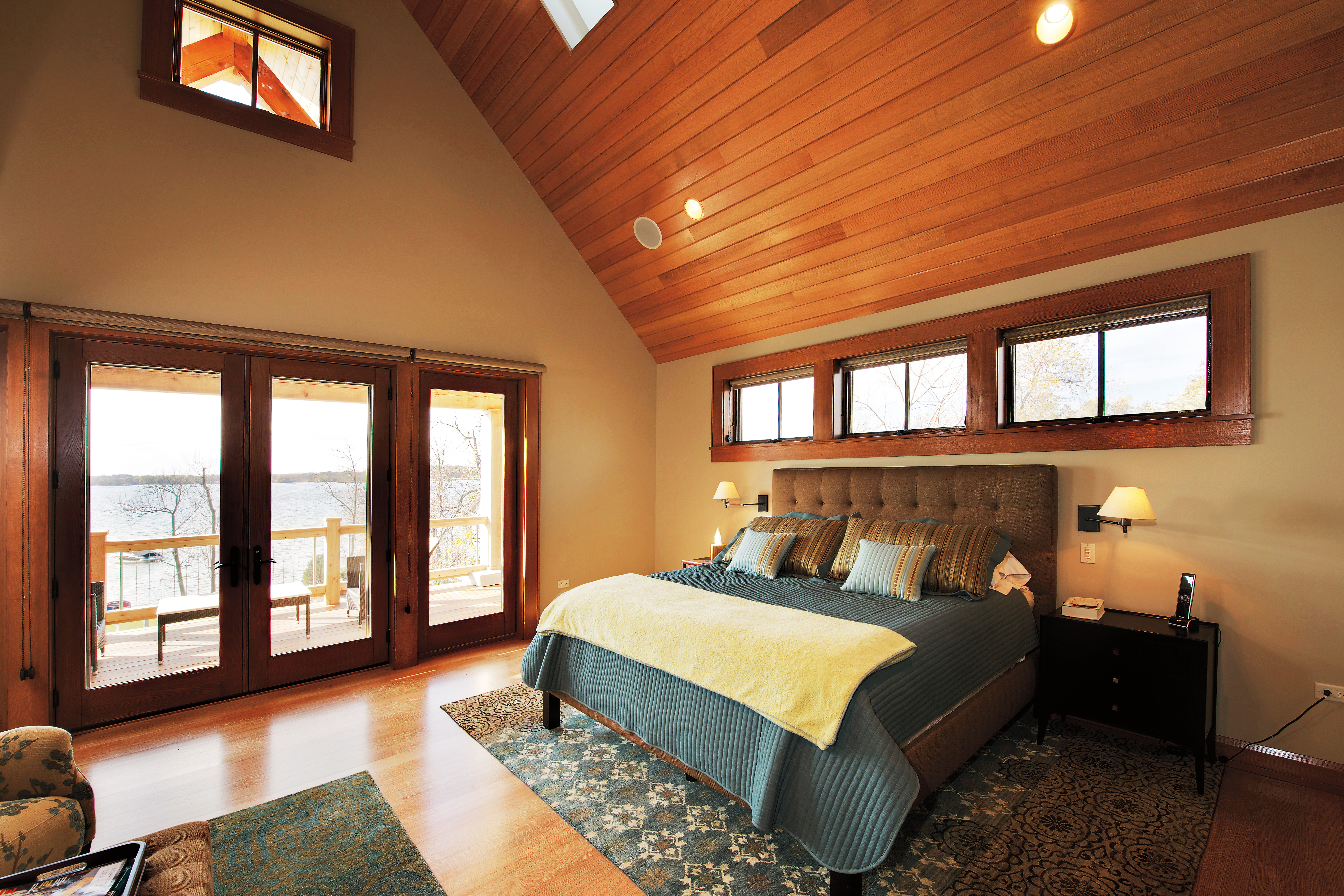Quarter sawn red oak interior wood-clad awning windows in a bedroom with a cathedral ceiling