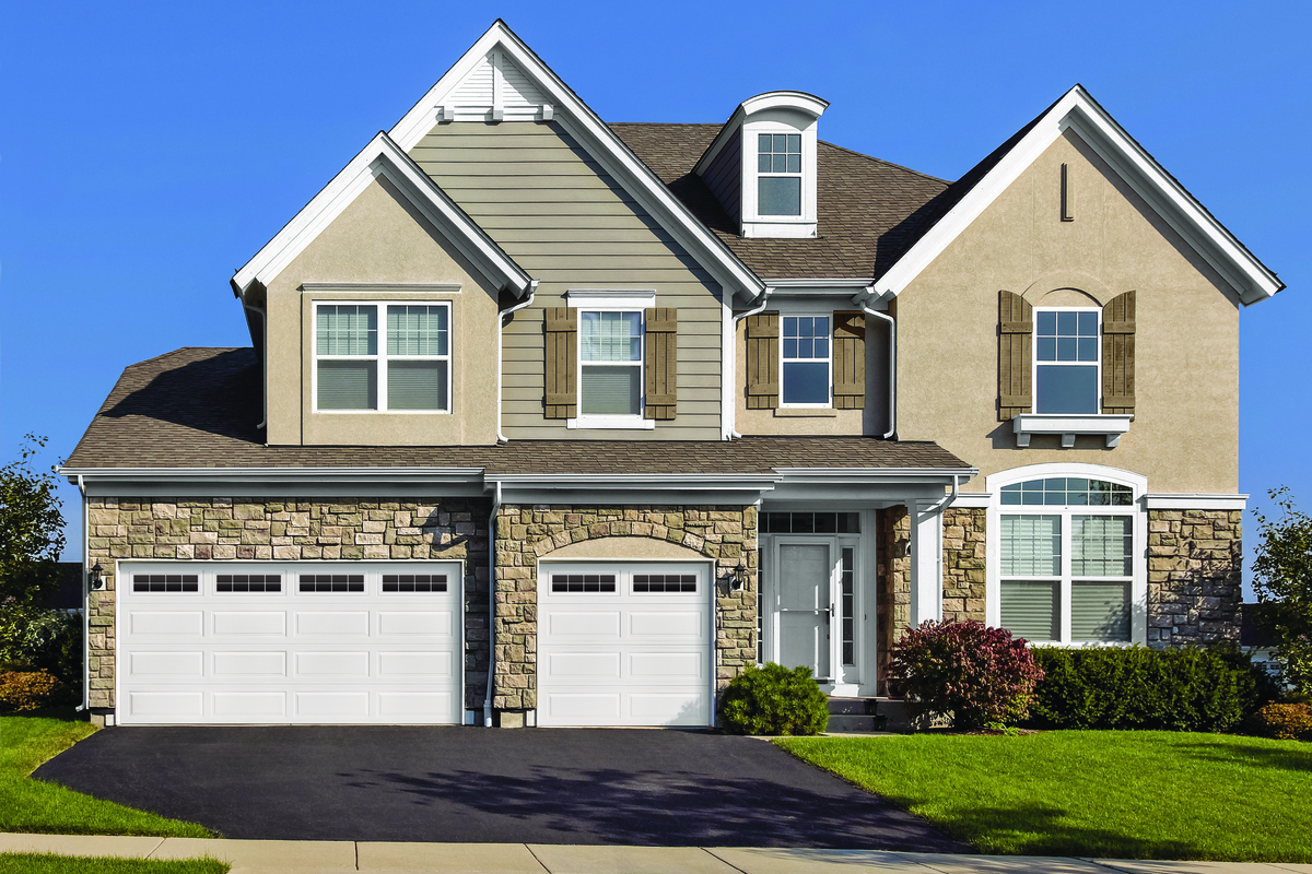 White Ranch Panel residential garage door with Stockton windows