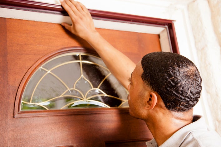 Man investigating the entry door of his home following recent installation.