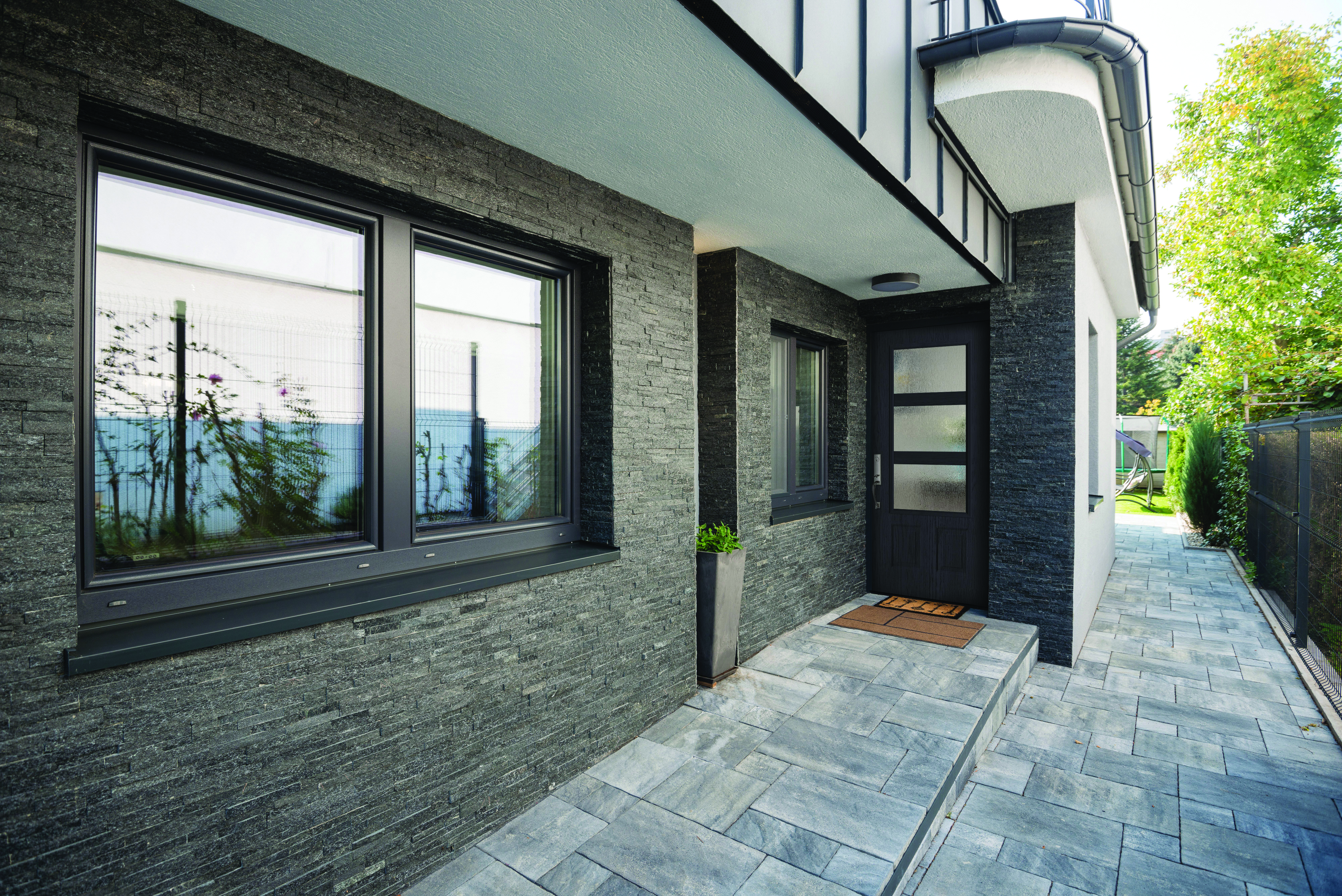 Textured Steel Entry Door, in a 3/4 Lite, 2 Panels door style and Modern Wide Simulated Divided Lites with Rain glass, prefinished in Obsidian, and with a Baldwin Del Mar Handleset in Satin Nickel.