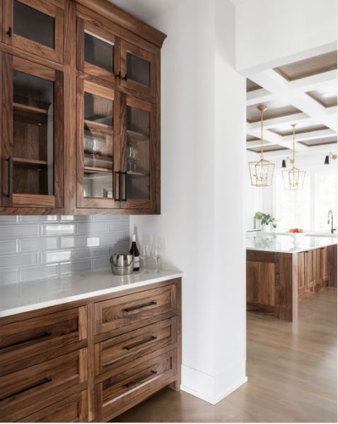 Wood stained cabinets in a beautiful white kitchen