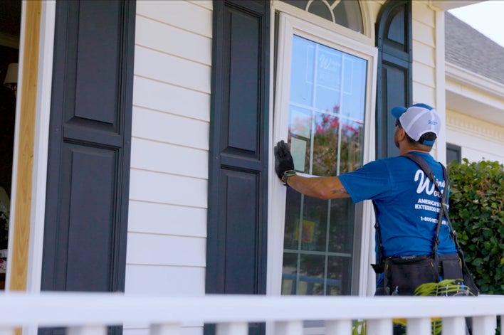 Window replacement contractor quickly installing a new energy-efficient window