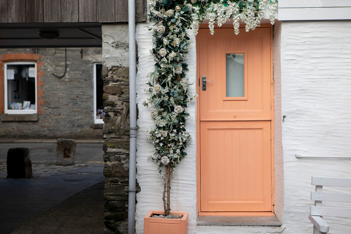 Pantone 2024 Color of the Year Peach Fuzz on a home’s front door