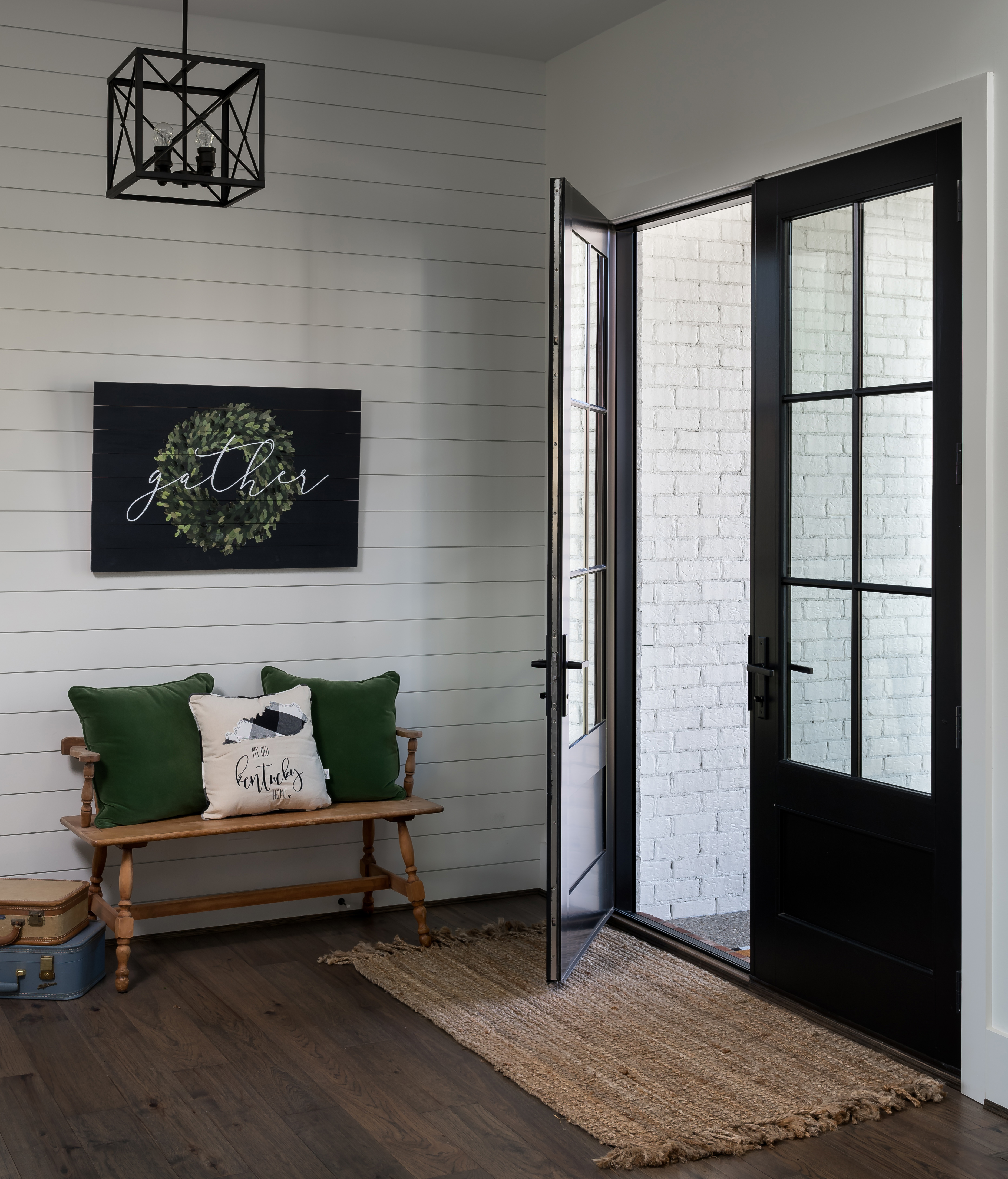 A opened black hinged patio door with a 3/4 lite