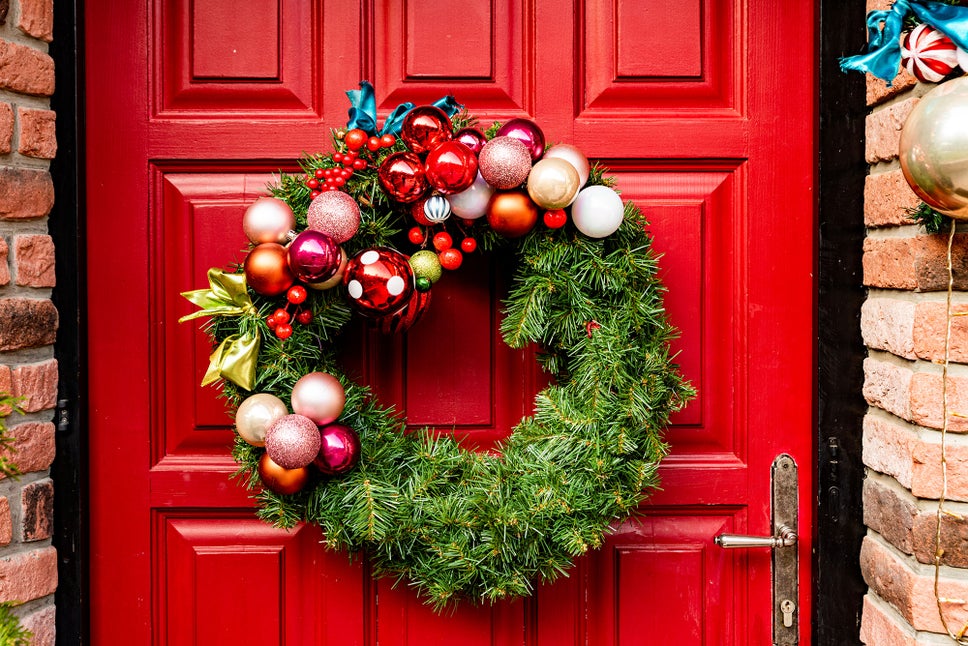 A Christmas wreath on a red front door