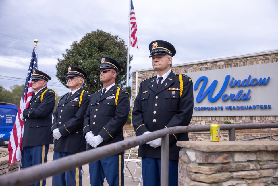 Military men standing in front of Window World's Corporate Office