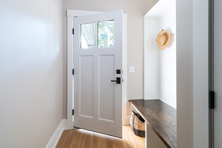 White front door in an entryway of a modern home