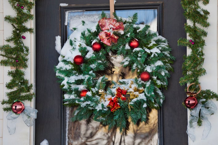A snowy wreath hanging on a door.