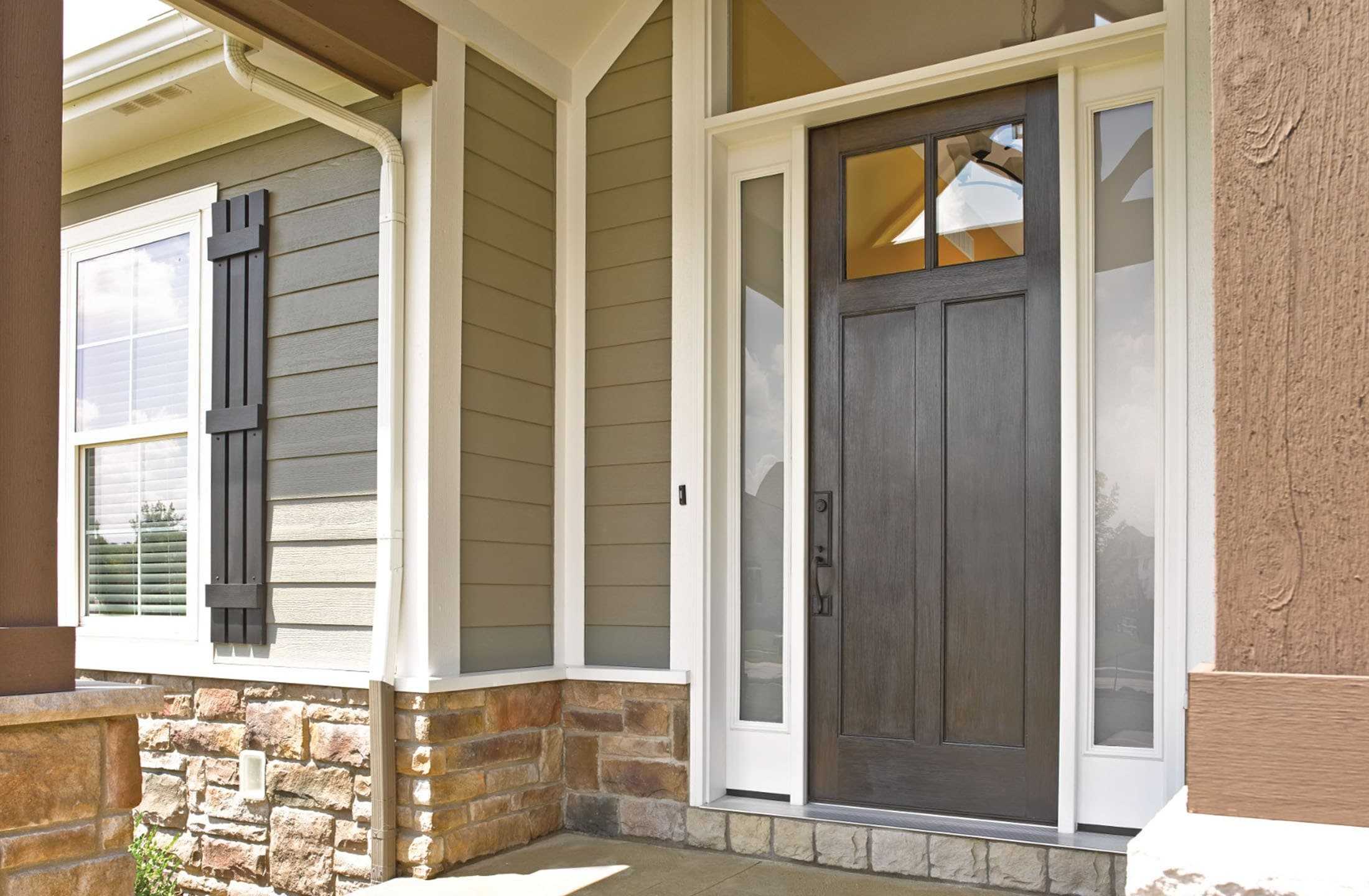 The entrance to a home with stacked-stone foundation details and an energy-efficient front door