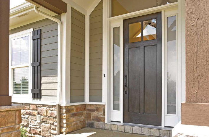 The entrance to a home with stacked-stone foundation details and an energy-efficient front door The entrance to a home with stacked-stone foundation details and an energy-efficient front door