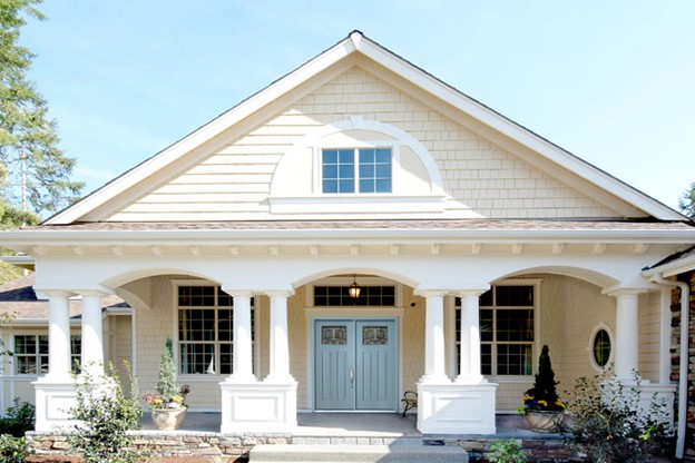 Off-white exterior house color with light blue front entry door