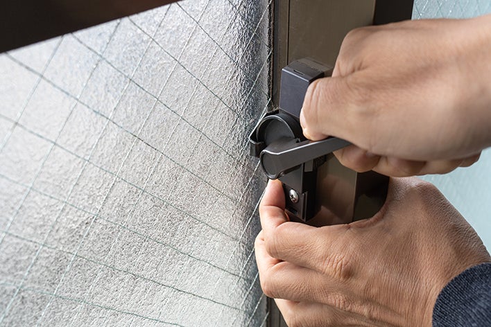 Hands Checking Window Locks