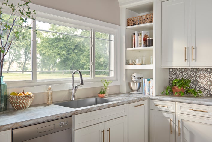 A kitchen with modern windows and light colors for an airy feel.