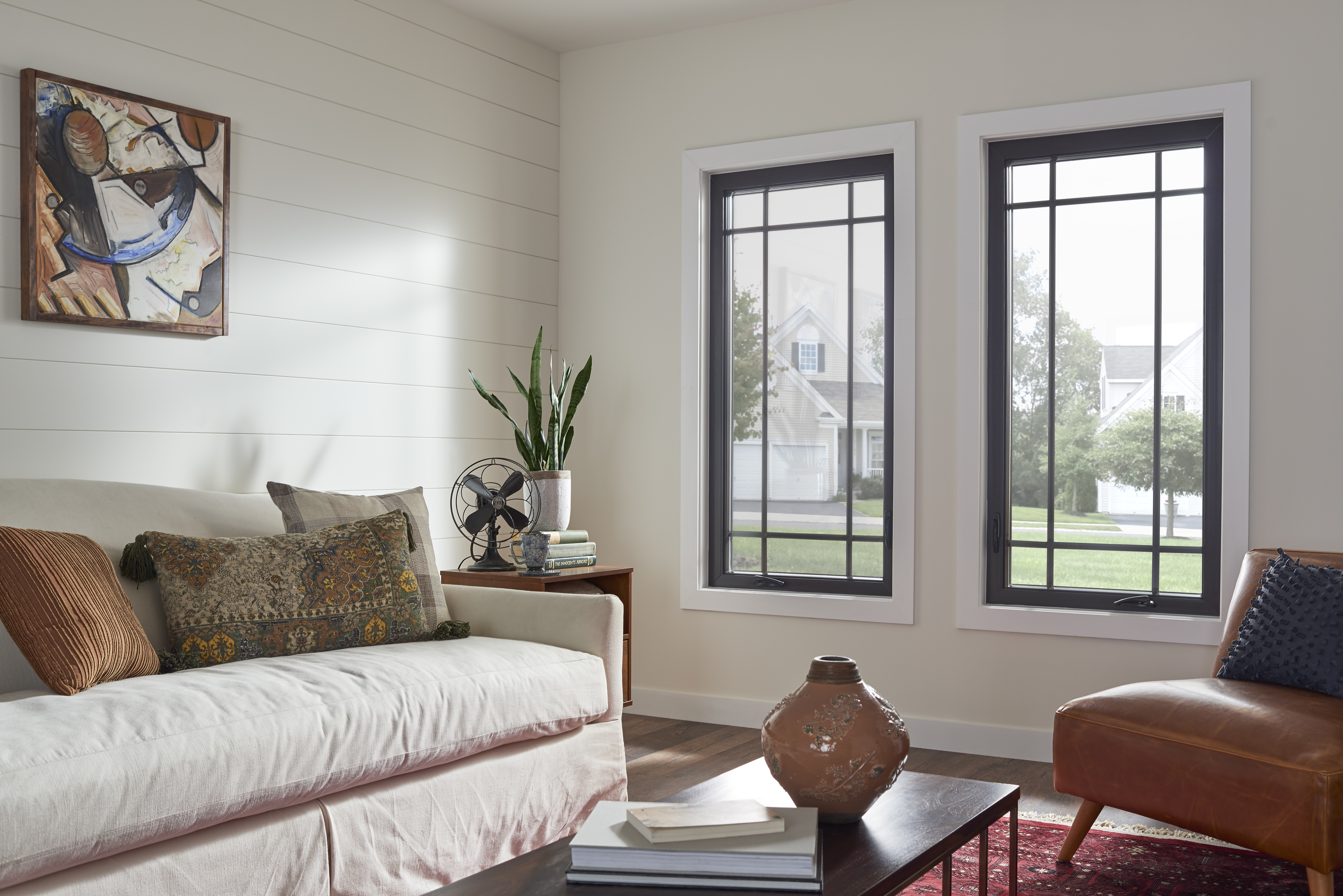 Modern casement windows with high-contrast casement grids in a living room.