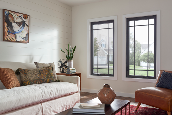 Modern casement windows with high-contrast casement grids in a living room.