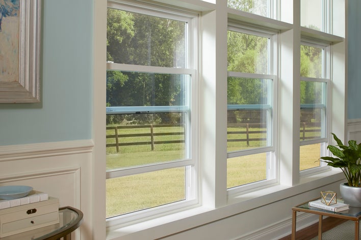 A row of functioning double-hung vinyl windows, opened to let in fresh air.