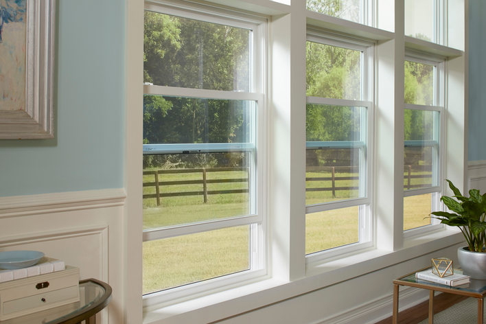 A row of functioning double-hung vinyl windows, opened to let in fresh air.