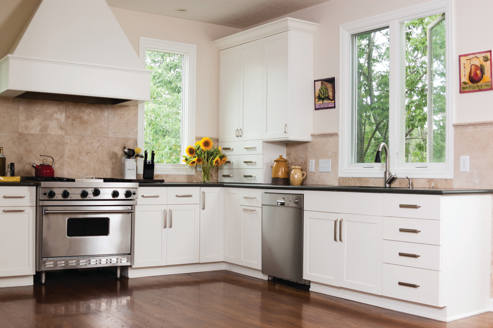 An open casement window in a kitchen allowing a breeze and unobstructed view