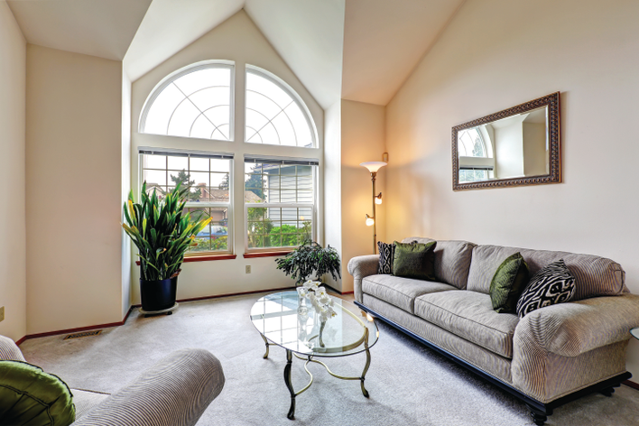 Custom architectural shape windows and double-hung windows from Window World in the living room of a home.